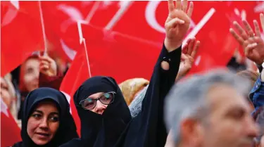  ??  ?? Joy: President Erdogan’s supporters wave flags as they await his arrival in Ankara yesterday