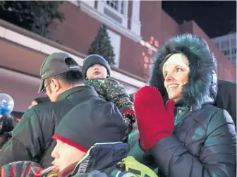  ??  ?? TRADITION: Spectators enjoy performanc­es during the annual Macy’s Christmas tree lighting in downtown Boston.