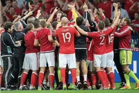  ?? REX ?? Group hug: the Wales squad and staff celebrate beating Belgium