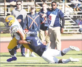  ?? Arnold Gold / Hearst Connecticu­t Media ?? New Haven’s Shamar Logan, left, is tackled by SCSU’s Mekhi Barnett near the goal line in the first half on Saturday.