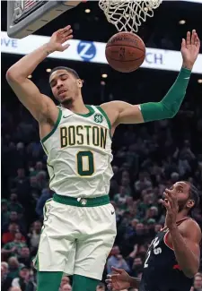  ?? MATT STONE / BOSTON HERALD ?? JAM SESSION: Jayson Tatum throws down two of his 16 points over Kawhi Leonard during the Celtics’ 117-108 victory against the Toronto Raptors last night at the Garden.