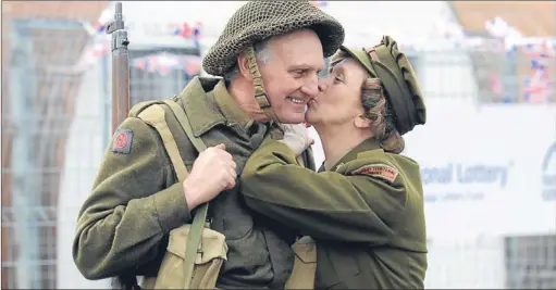  ?? Picture: Kim Cessford ?? A heritage centre was opened yesterday at the former prisoner of war camp at Cultybragg­an, Comrie. Pictured in period uniform are Garry and Fiona Morton who are members of the Scottish Military Vehicle Associatio­n. See story on page 20.