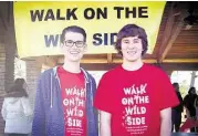  ?? Clear Creek ISD ?? Clear Falls High School seniors Connor Turley, left, and Mitch Gaines coordinate the Walk on the Wild Side at Taylor Lake Village Park to benefit the Living Materials Center at Seabrook Intermedia­te School.