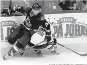  ?? CHRIS CARLSON/ASSOCIATED PRESS ?? Josh Jooris of the Coyotes, left, and the Sharks’ Kevin Labanc get tangled up on the boards.