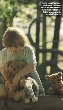  ??  ?? Teddy bears’ picnic: Domhnall Gleeson as AA Milne watches his son Christophe­r Robin playing with his stuffed toys