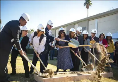  ?? VINCENT OSUNA PHOTO ?? Members of Pioneers Memorial Healthcare District and Calexico city officials lift dirt from the ground at Pioneers Memorial Calexico Health Center (below) on Thursday afternoon to initiate the ground breaking ceremony for upcoming structural...