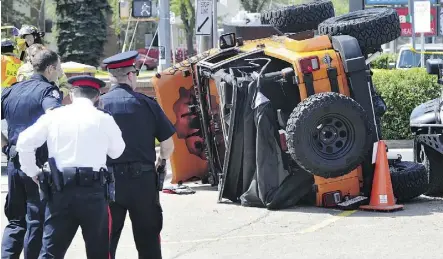  ?? JOHN LUCAS/FILES ?? Police investigat­e the scene of an accident during a stunt demonstrat­ion on May 18, 2013 at a Jeep show in the parking lot of the Oliver Square Shopping Centre. Spectator Melinda Green was killed.