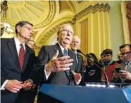  ?? THE ASSOCIATED PRESS ?? Senate Majority Leader Mitch McConnell, R-Ky., joined by, from left, Sen. John Barrasso, R-Wyo., Sen. Roy Blunt, R-Mo., and Majority Whip John Cornyn, R-Texas, speaks with reporters Tuesday at the Capitol in Washington.