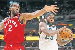  ?? RICK BOWMER THE ASSOCIATED PRESS ?? The Raptors’ Kawhi Leonard, defending against Utah forward Royce O'Neale, has made quick progress in his first two pre-season games.