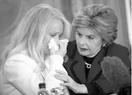  ?? DREW ANGERER/GETTY IMAGES ?? Rocxanne Deschamps, left, who took in Parkland suspect Nikolas Cruz and his brother, Zachary, is consoled by her attorney, Gloria Allred, at a press conference in New York City.