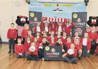 ??  ?? Billy Jones, front left, and Adam Matthews visit Marsden Primary School to launch the Fan Fest fun day.