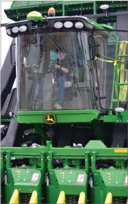  ?? RECORDER PHOTO BY ALEXIS ESPINOZA ?? Keith Gentry sits in a large piece of farming equipment, and smiles down as expo vistors pass below him Thursday, Feb. 14 at the World Ag Expo in Tulare.