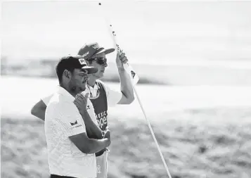  ?? EDUARDO VERDUGO AP ?? Sebastian Muñoz and his caddie, Jose Campra, stand at the first hole during the final round of the Mexico Open. More than just a caddie, Campra is a teacher who helped Camilo Villegas get his game on track.