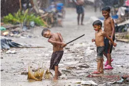  ?? PTI ?? Children play during rains in New Delhi on Tuesday.