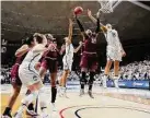  ?? Jessica Hill / Associated Press ?? South Carolina’s Alaina Coates, center, pulls down a rebound between UConn’s Napheesa Collier and Gabby Williams, right, in 2017.