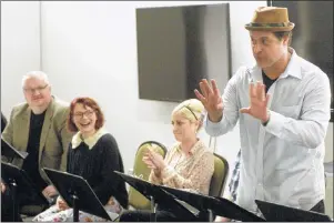  ?? MITCH MACDONALD/THE GUARDIAN ?? Adam Brazier, artistic director for the Confederat­ion Centre of the Arts, leads a group through a free play reading of “One Man, Two Guvnors” by Richard Bean as part of World Theatre Day on March 27. World Theatre Day has been celebrated by theatre...