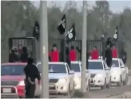  ??  ?? A screenshot from a video released by Islamic State on Saturday shows what the terror group claims are captured Kurdish peshmerga fighters being paraded through Kirkuk
in cages.