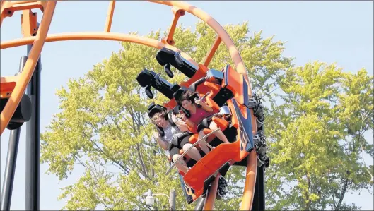  ?? CHRIS SWEDA/CHICAGO TRIBUNE ?? People ride one of the roller coasters at Indiana Beach amusement park in Monticello, Indiana on Aug. 31, 2011.