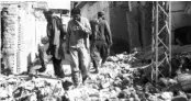  ?? PHOTO: PTI ?? Residents walk amid the rubble of damaged houses along a street after an earthquake hit Balochista­n