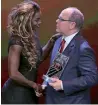  ?? — AFP ?? Caterine Ibarguen receives her award from Prince Albert II of Monaco.