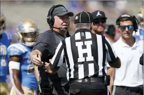  ?? ASHLEY LANDIS — THE ASSOCIATED PRESS ?? UCLA head coach Chip Kelly talks with an official during the first half of an NCAA college football game against Utah in Pasadena Saturday, Oct. 8, 2022.