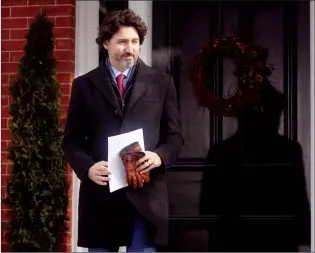  ?? CP PHOTO ADRIAN WYLD ?? Prime Minister Justin Trudeau walks to the podium from Rideau cottage for a news conference on Tuesday in Ottawa.