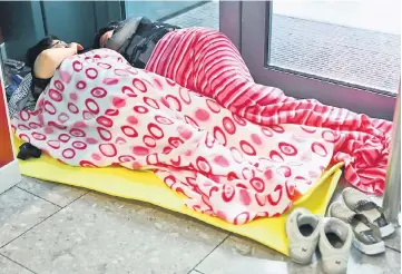  ??  ?? People sleep at Heathrow Terminal 5 in London. — Reuters photo