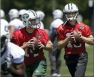  ?? MARK LENNIHAN — THE ASSOCIATED PRESS ?? New York Jets quarterbac­ks Sam Darnold, left, and Josh McCown, right, throw during the NFL football team’s training camp, Tuesday in Florham Park, N.J.