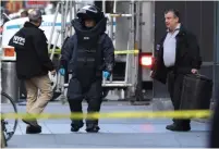  ?? (Kevin Coombs/Reuters) ?? A MEMBER of the NYPD bomb squad outside the Time Warner Center in Manhattan yesterday, after a suspicious package was found inside the CNN Headquarte­rs.