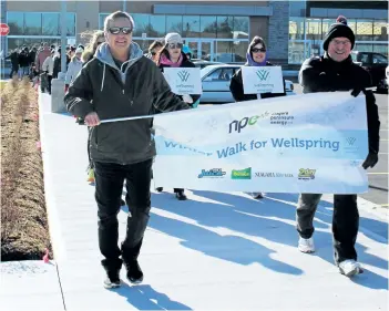  ?? ALLAN BENNER/POSTMEDIA NETWORK ?? Terry Purser and Joe Matthews lead about a hundred people on a walk through the streets of Fonthill Saturday during Wellspring Niagara's inaugural Winter Walk for Wellspring.