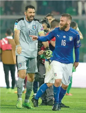  ?? — AFP ?? Italy’s goalkeeper Gianluigi Buffon (left) jokes with Daniele De Rossi at the end of the Fifa World Cup 2018 qualificat­ion match against Albania on Friday at Renzo Barbera stadium in Palermo.