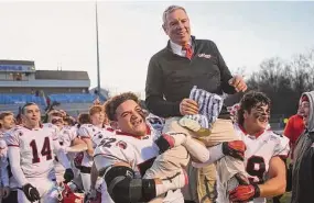  ?? Brian A. Pounds/Hearst Connecticu­t Media ?? New Canaan Coach Lou Marinelli is carried from the field on the shoulders of players Javier Perez-Soto, left, and Will Pepe following their 16-13 victory over Maloney in the CIAC Class L championsh­ip at CCSU’s Arute Field in New Britain on Dec. 10. The Rams will open their season at Shelton in an alliance game.