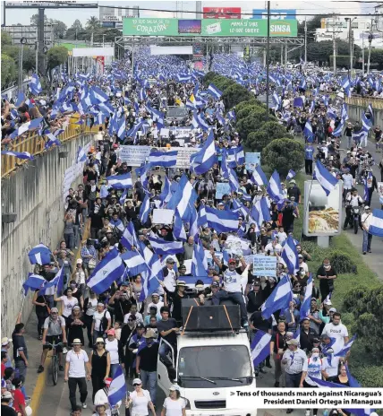  ??  ?? > Tens of thousands march against Nicaragua’s President Daniel Ortega in Managua