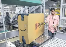  ??  ?? An employee scans the bar code on a package at the Amazon.com fulfillmen­t centre in Hyderabad, India.