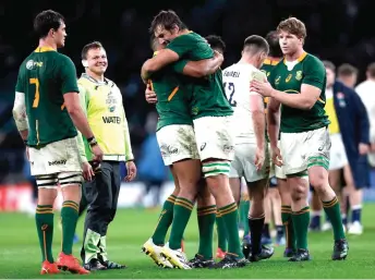  ?? — AFP photo ?? South Africa players celebrate after their 13-27 win over England at Twickenham Stadium in London.