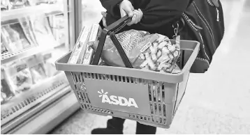  ??  ?? Shoppers leave the Asda superstore in High Wycombe, Britain. Wal-Mart is throwing its weight as the world’s largest retailer behind its struggling British arm Asda after admitting it was too slow to respond effectivel­y to the threat posed by the...