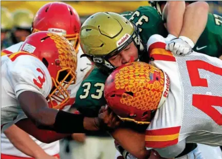  ?? BOB RAINES — DIGITAL FIRST MEDIA ?? Lansdale Catholic’s Matt Casee stopped by Haverford’s Shane Mosley and Jon Klee Saturday night.