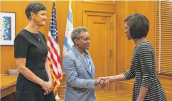  ?? ASHLEE REZIN/SUN-TIMES ?? Mayor Lori Lightfoot and her wife, Amy Eshleman, meet one of hundreds of constituen­ts during an open house at City Hall after Lightfoot’s inaugurati­on on Monday.