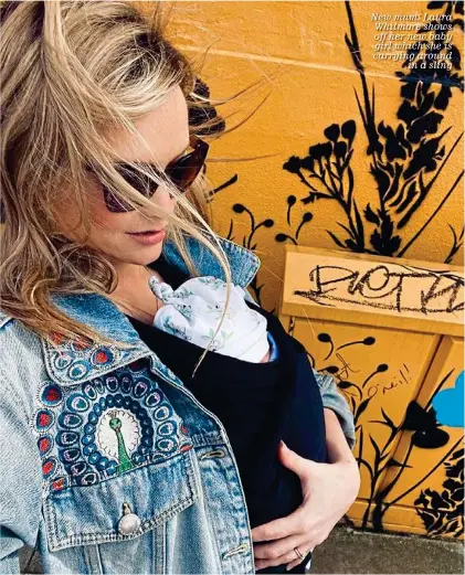  ??  ?? New mum: Laura Whitmore shows off her new baby girl which she is carrying around in a sling