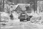  ?? BRIAN VAN DER BRUG/LOS ANGELES TIMES ?? Big Bear Lake streets are still choked with snow following successive storms which blanketed San Bernardino Mountain communitie­s on Friday.