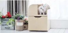  ?? TUFT + PAW ?? This beautiful, modern litter box lets cats exercise their natural inclinatio­n to climb, while a divider gives them privacy as well.