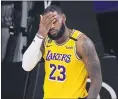  ?? MARK J. TERRILL— THE ASSOCIATED PRESS ?? The Lakers’ LeBron James wipes his face after being fouled during a conference final playoff game against the Nuggets on Thursday in Lake Buena Vista, Fla. The Lakers won 114-108.