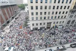  ?? ELIZABETH CONLEY/AP ?? Protestors fill Walker and Travis streets in Houston as they make their way to U.S. Sen. Ted Cruz’s office during an immigratio­n rally on Saturday.