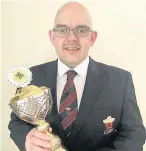  ??  ?? Glyn Williams, Cory Solo Euphonium with his European Champion Soloist Trophy
