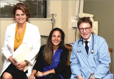  ??  ?? Michelle Burnett was the second patient in the world to enroll in an internatio­nal colorectal cancer study at Ingalls. Pictured, from left, are Ingalls Cancer Research Nurse Joy Vlamakis, R. N., Michelle Burnett and Mark Kozloff, M. D.