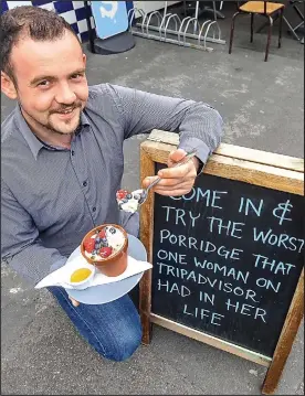  ??  ?? Porridge putdown: Cafe boss Arlo Calderbank with his witty board