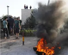 ??  ?? Israeli settlers burn tyres to protest against the evacuation of homes at Netiv Haavot settlement near Bethlehem, in the occupied West Bank. — AFP photo