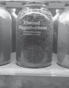  ?? EQUAL JUSTICE INITIATIVE ?? A glass vessel containing soil collected from the Higginboth­am lynching site is displayed in a gallery at the National Memorial for Peace and Justice in Montgomery, Ala.