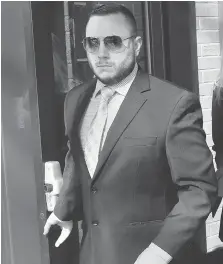  ?? DAN JANISSE ?? OPP Const. Jamie Porto leaves court on Wednesday after receiving a 12-month driving prohibitio­n and a $2,500 fine for dangerous driving causing bodily harm for an October 2014 crash in St. Joachim.