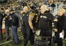  ?? PETER POWER, THE CANADIAN PRESS ?? Cats offensive lineman Mike Filer says hello to former Hamilton Tiger-Cat Angelo Mosca, and members the Grey Cup champion 1967 team.